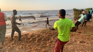 men pulling a fishing net