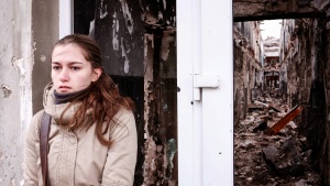 A young woman waits outside a building in Kurakhove, Eastern Ukraine.