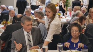 Teens serving a meal.