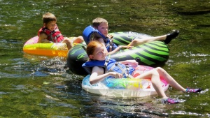 Campers on a river float. 