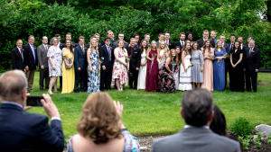 The class of 2019 smiles for a group photo with faculty after the graduation ceremony.