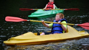 Campers canoe on the river at Camp Tomahawk.