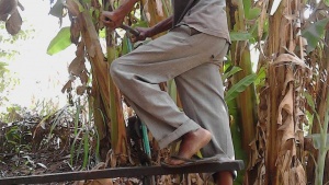 man running manual pump for dam