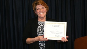 Linda “Andi” Chapman holding her “Educator of the Year” award. 