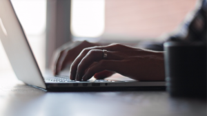 This is a photo of a person typing on a laptop computer.