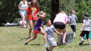 Members having a fun water balloon fight.