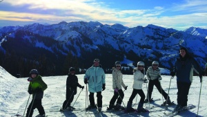 In this photos skiers pose in front of a magnificent view of mountains. Visitors from various parts of the U.S. came to Utah for the Salt Lake City Ski Weekend.