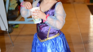 Isabelle White dressed as a TV princess enjoying a hot chocolate drink.