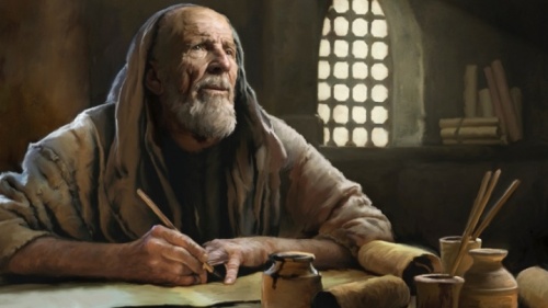 Un homme ancien écrit sur un parchemin