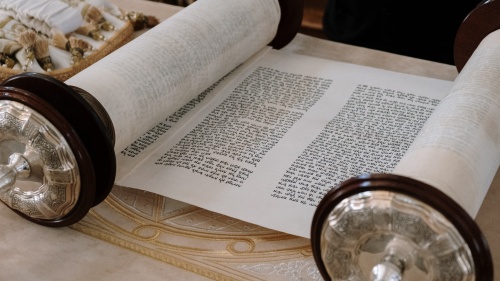 a Hebrew scroll rolled partially open to reveal text