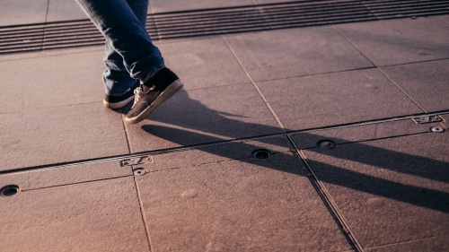 Shadow of a person&#039;s legs.