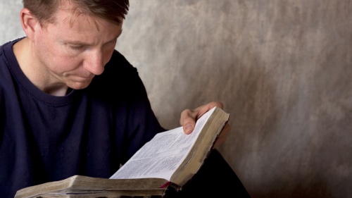 A man reading a Bible.