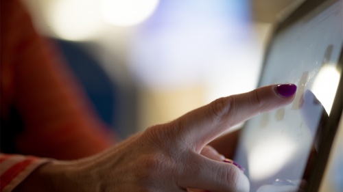 A woman using a touch screen.