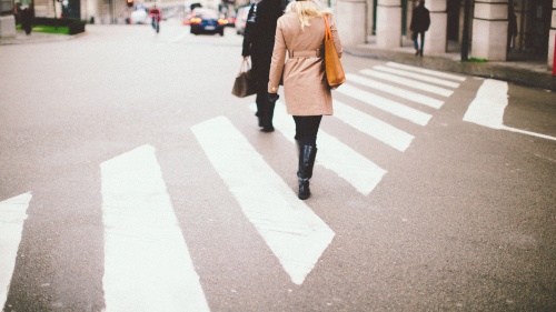 People walking across a street.