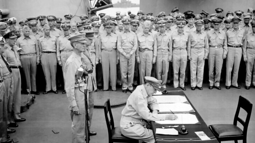 General of the Army Douglas MacArthur signing the Instrument of Surrender on behalf of the Allied Powers.