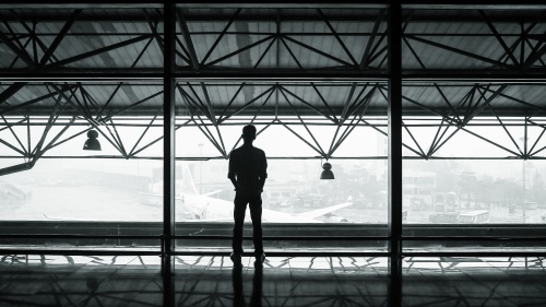 A person standing by a window.