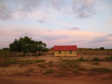 Red and yellow house in farmland