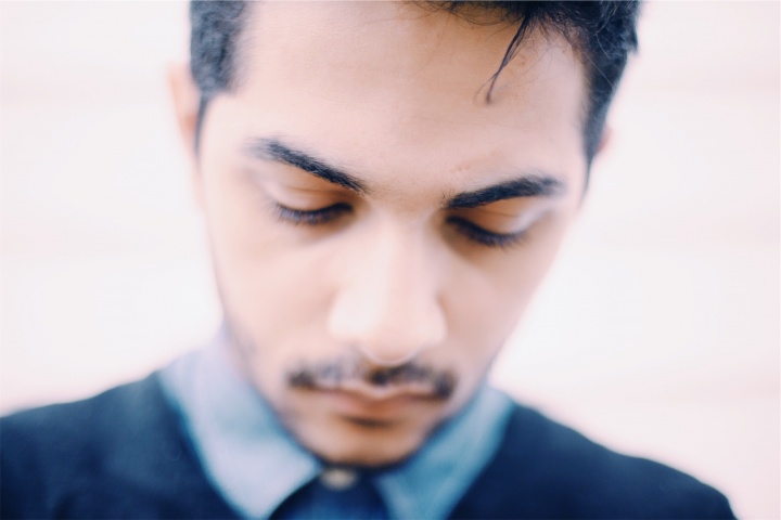 A young man looking down.