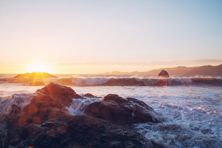 Sunset over a rocky beach.