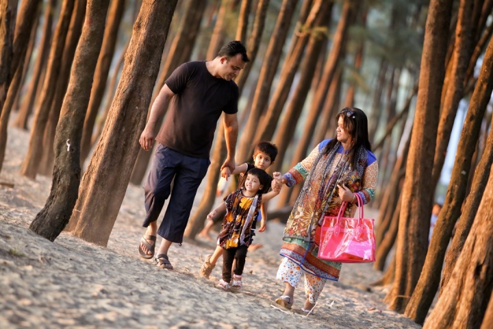 A family walking together on the beach.