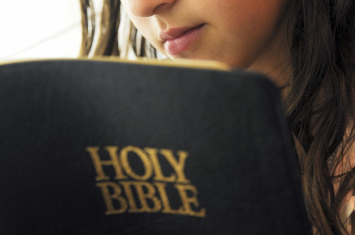 A woman reading a Bible.