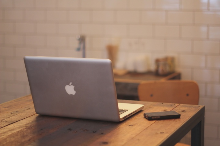 A laptop and smartphone on a table.