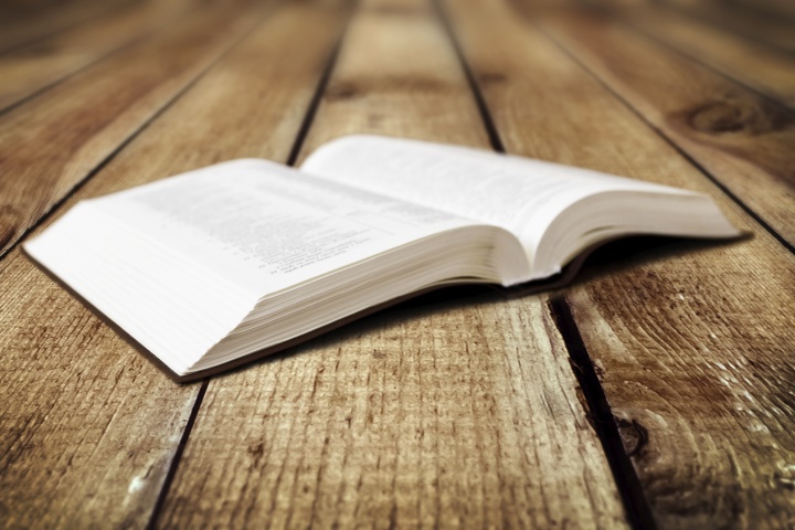 A open Bible laying on a table.