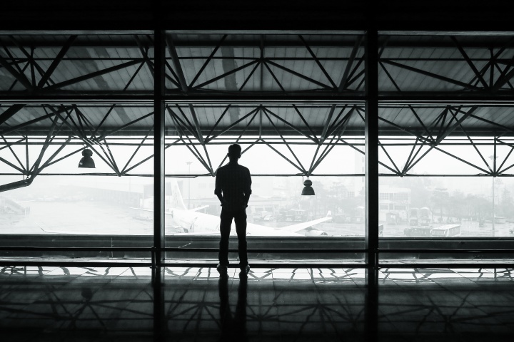 A person standing by a window.