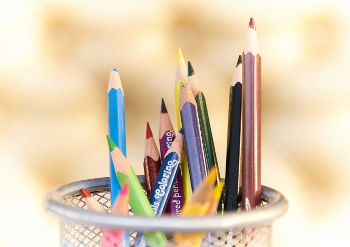 colored pencils in a metal basket