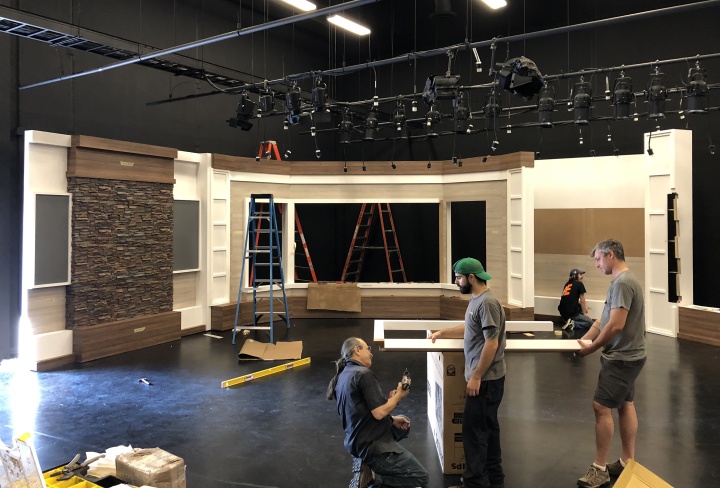 Workers installing the new Beyond Today set in the new studio.