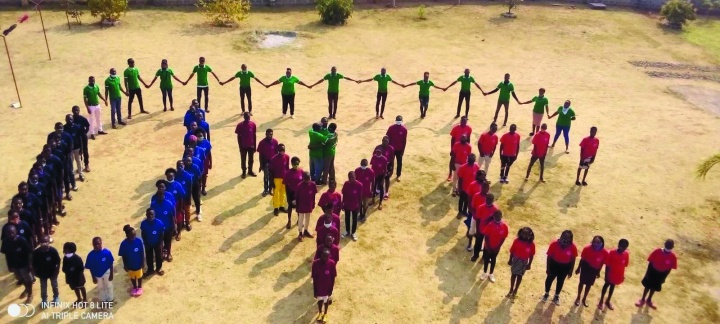 Aerial shot of campers and staff working together to form the UYC sign.